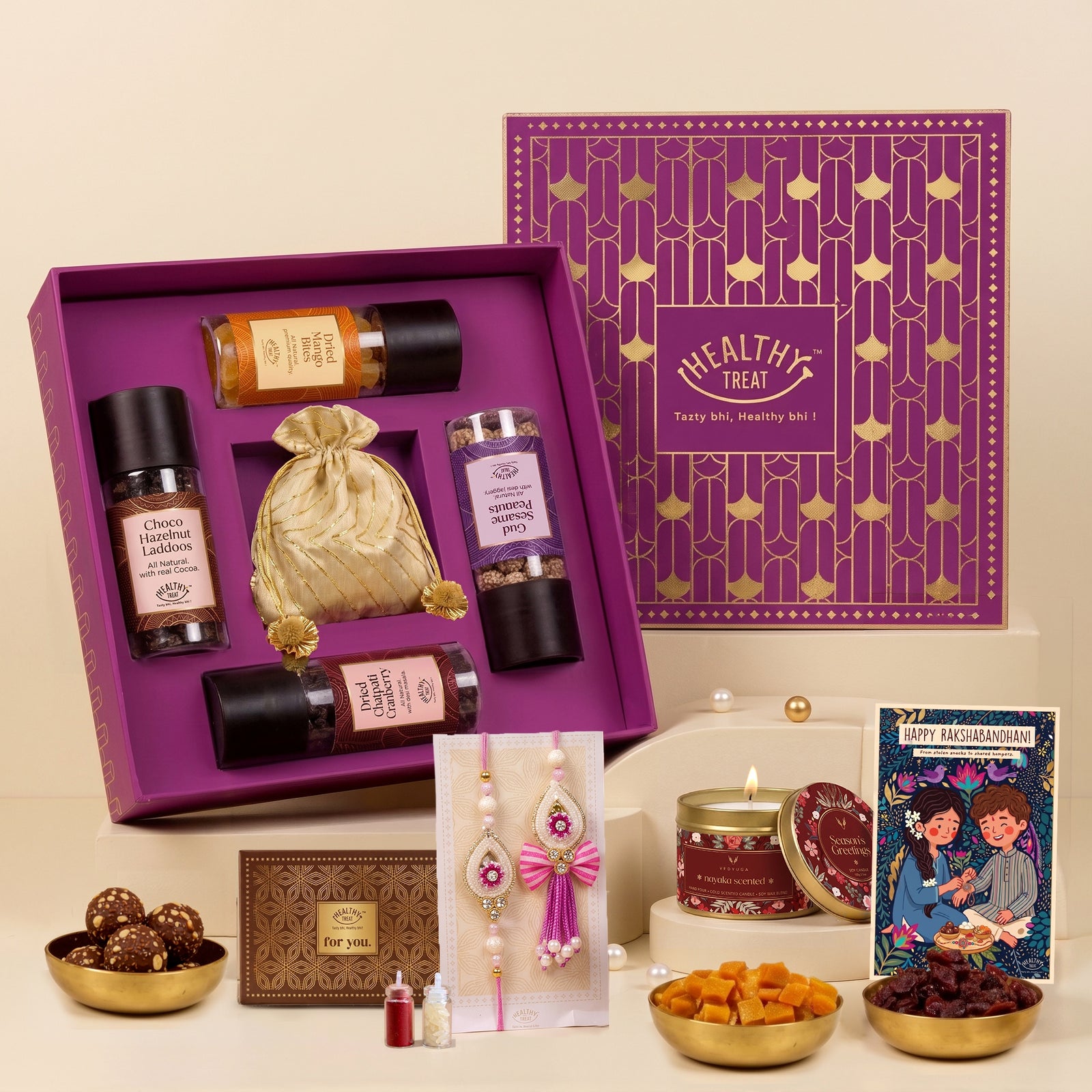 Utsav Rakhi Gift Hamper | Chatpati Cranberry, Dried Mango, Gud Sesame Peanut, Chocolate Hazelnut Laddoo, Scented Candle, Handmade Rakhi Pair, Roli Chawal & Greeting Card